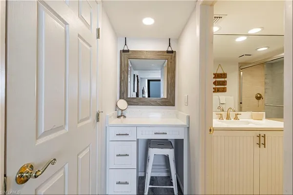 a bathroom with a sink toilet double vanity and shower