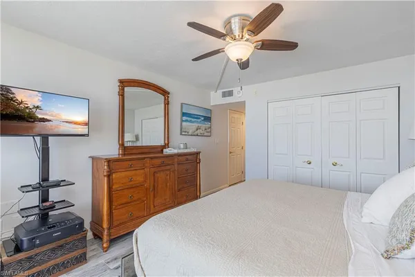 a bedroom with a bed and a television in it