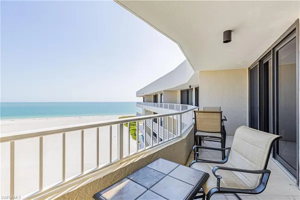 a view of a balcony with table and chairs