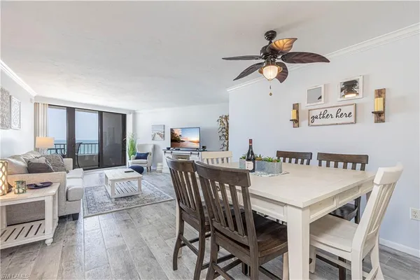 a view of a dining room with furniture and a chandelier