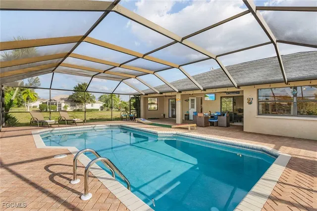 a view of a kitchen with a sink and dishwasher a dining table with chairs