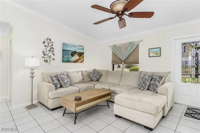 a living room with furniture a ceiling fan and a window