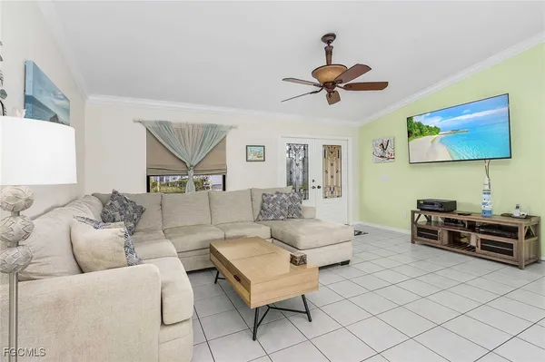 a living room with furniture and a chandelier