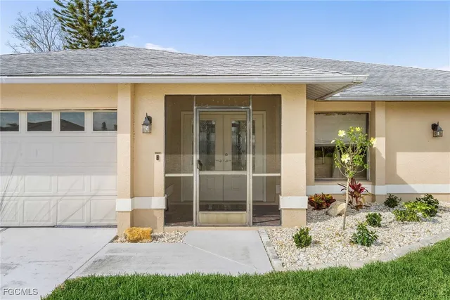 an aerial view of residential houses with outdoor space and lake view