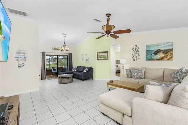 a living room with furniture and a ceiling fan