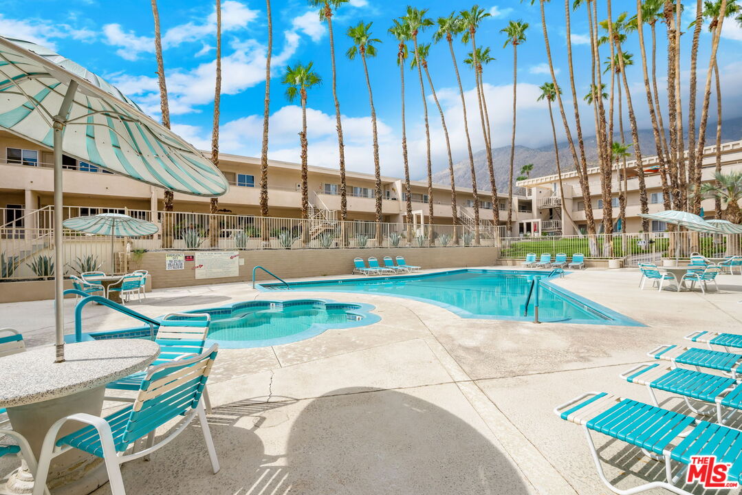 277 East Alejo Road, Unit 219 Palm Springs, CA 92262 - Photo 1 of 28 a view of a swimming pool with a patio