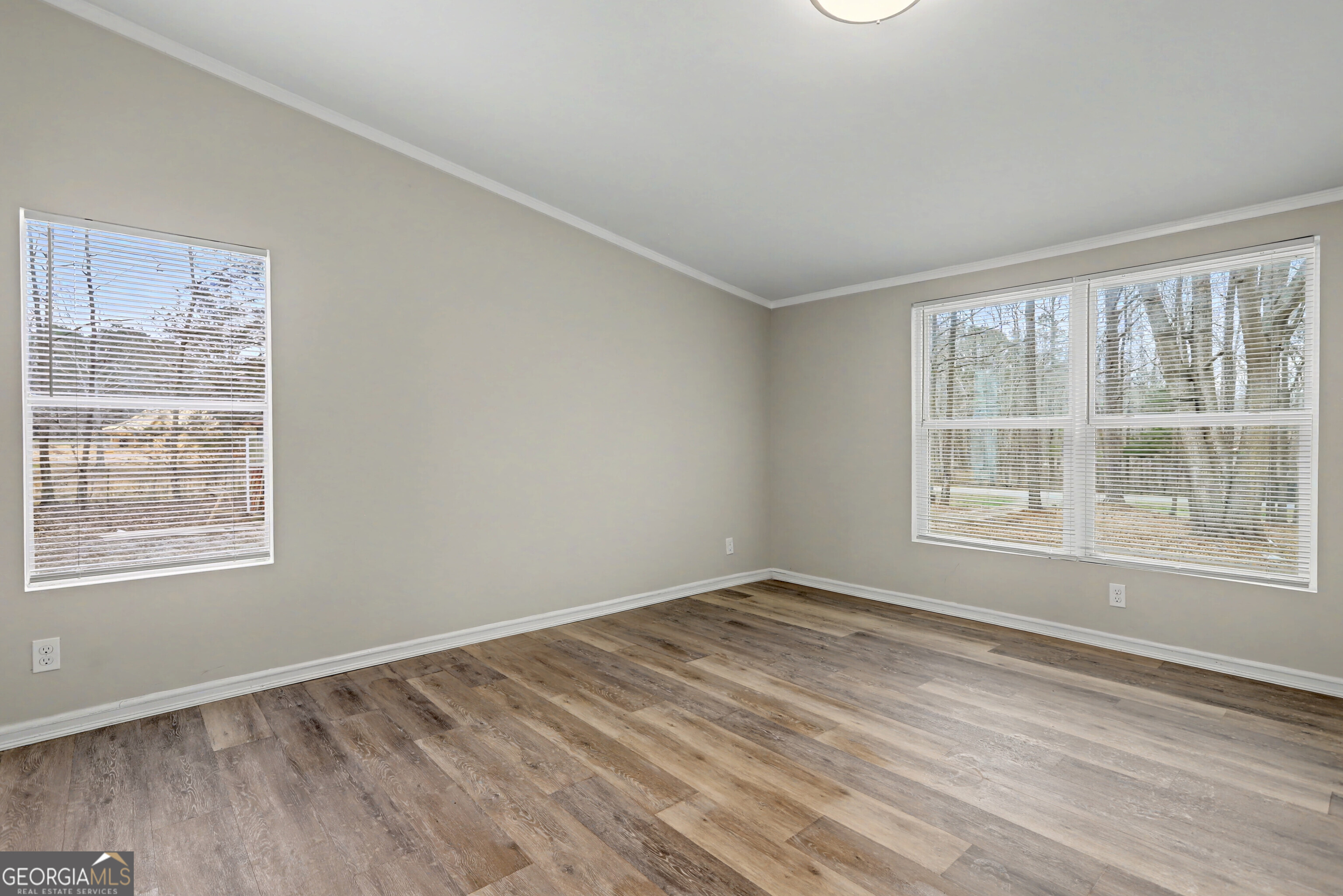 194 McKneely Road Milner, GA 30257 - Photo 11 of 30 a view of an empty room with wooden floor and a window