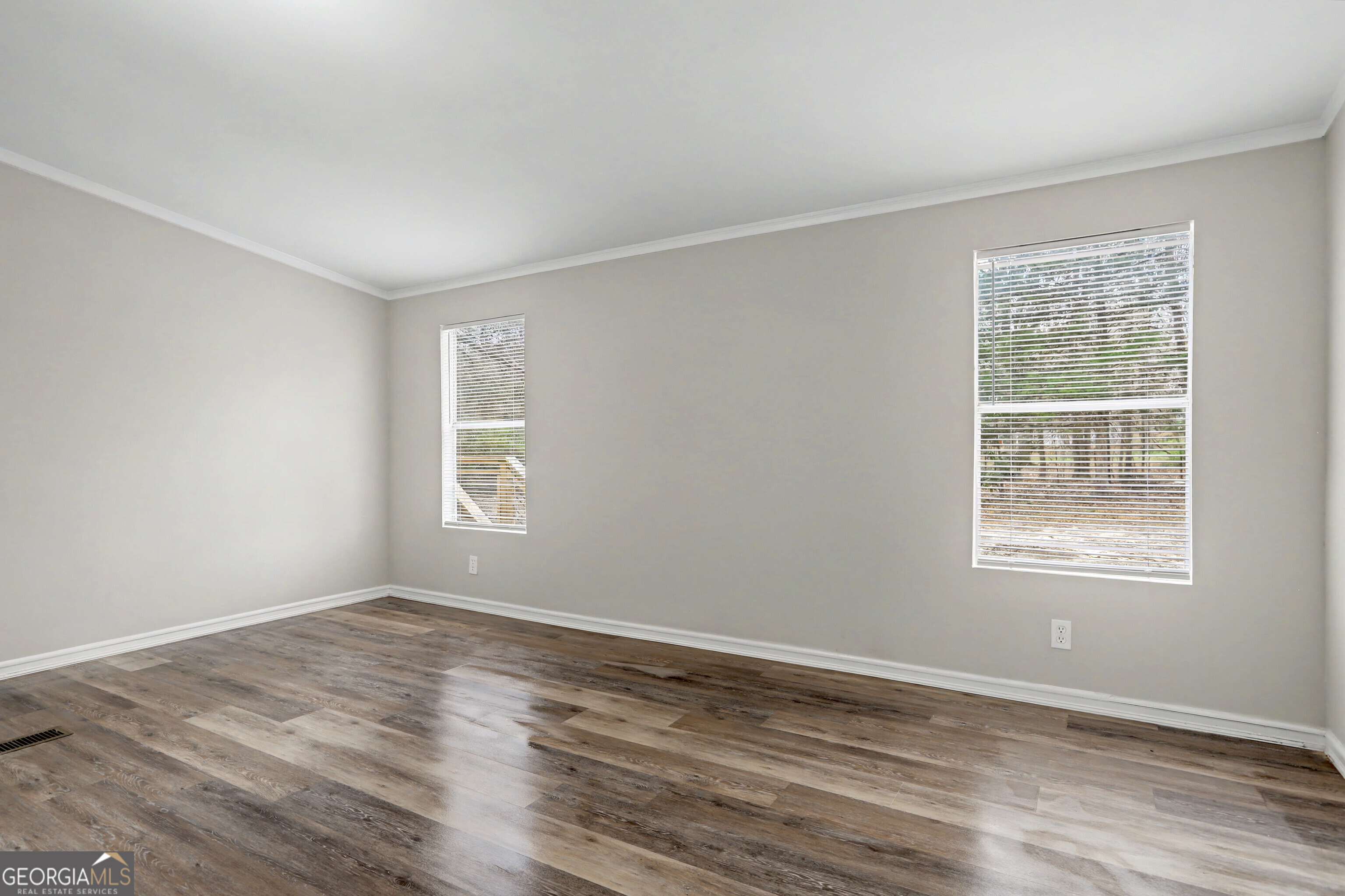 194 McKneely Road Milner, GA 30257 - Photo 15 of 30 a view of an empty room with wooden floor and a window