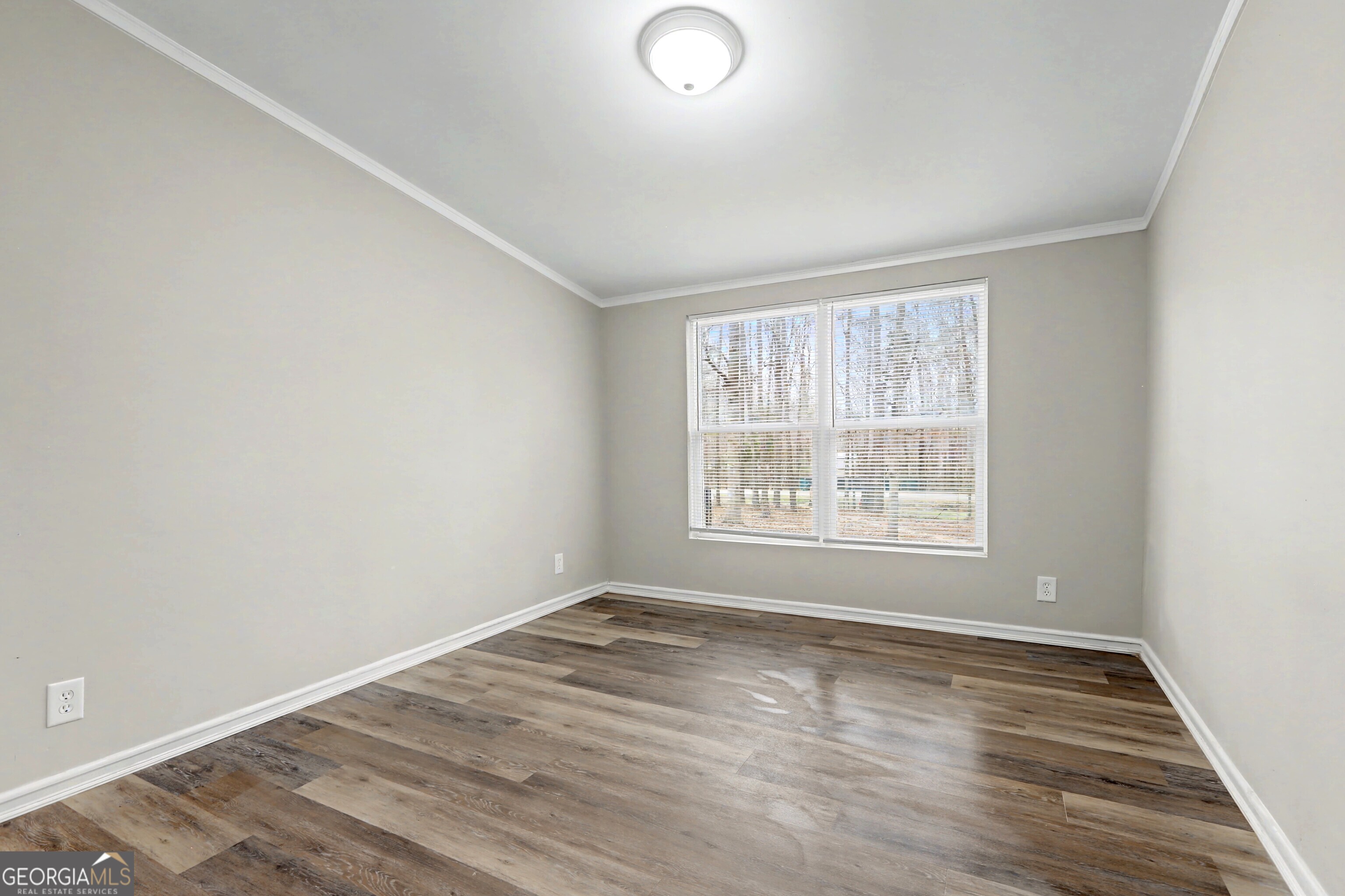 194 McKneely Road Milner, GA 30257 - Photo 18 of 30 an empty room with wooden floor and windows