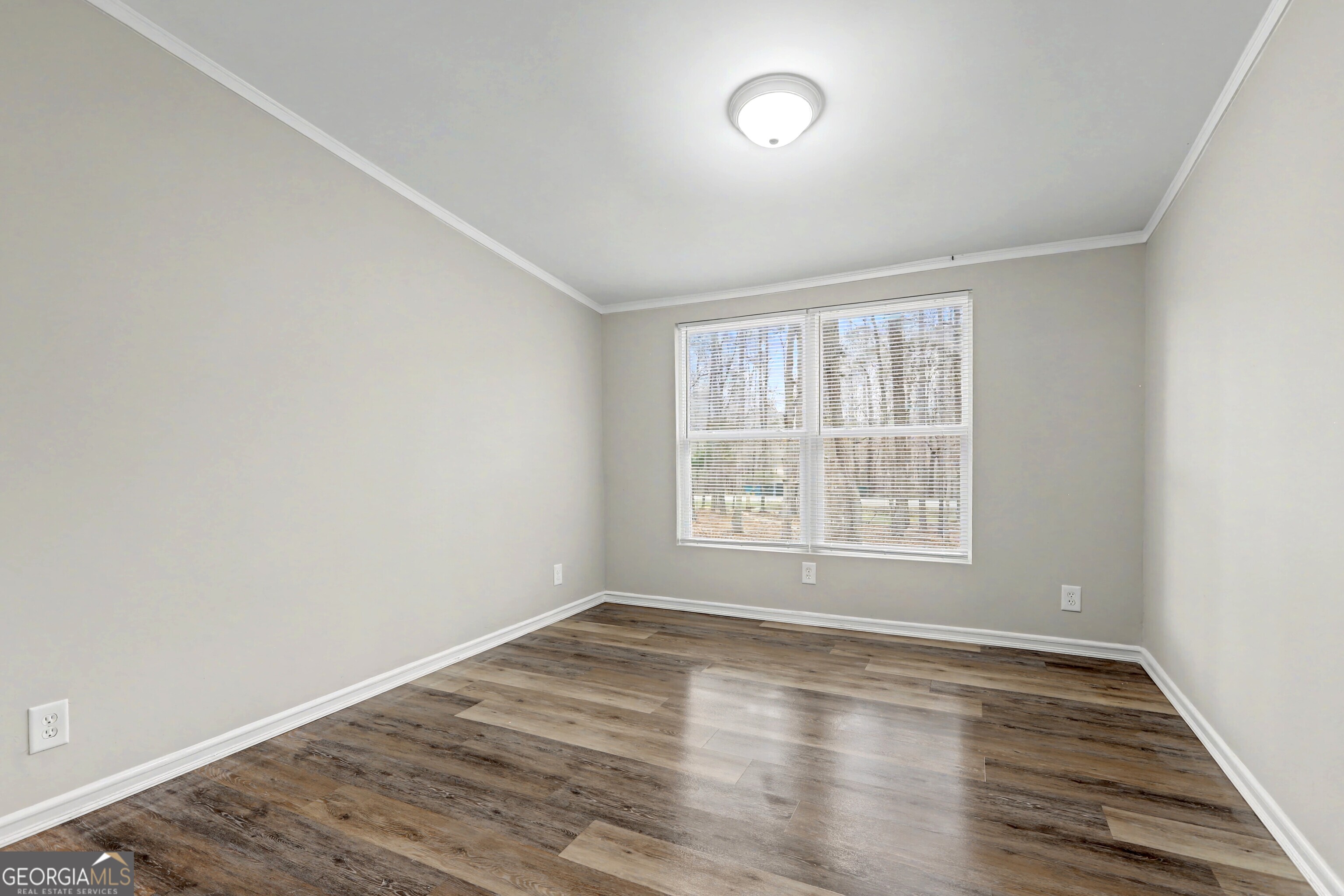 194 McKneely Road Milner, GA 30257 - Photo 20 of 30 an empty room with wooden floor and windows