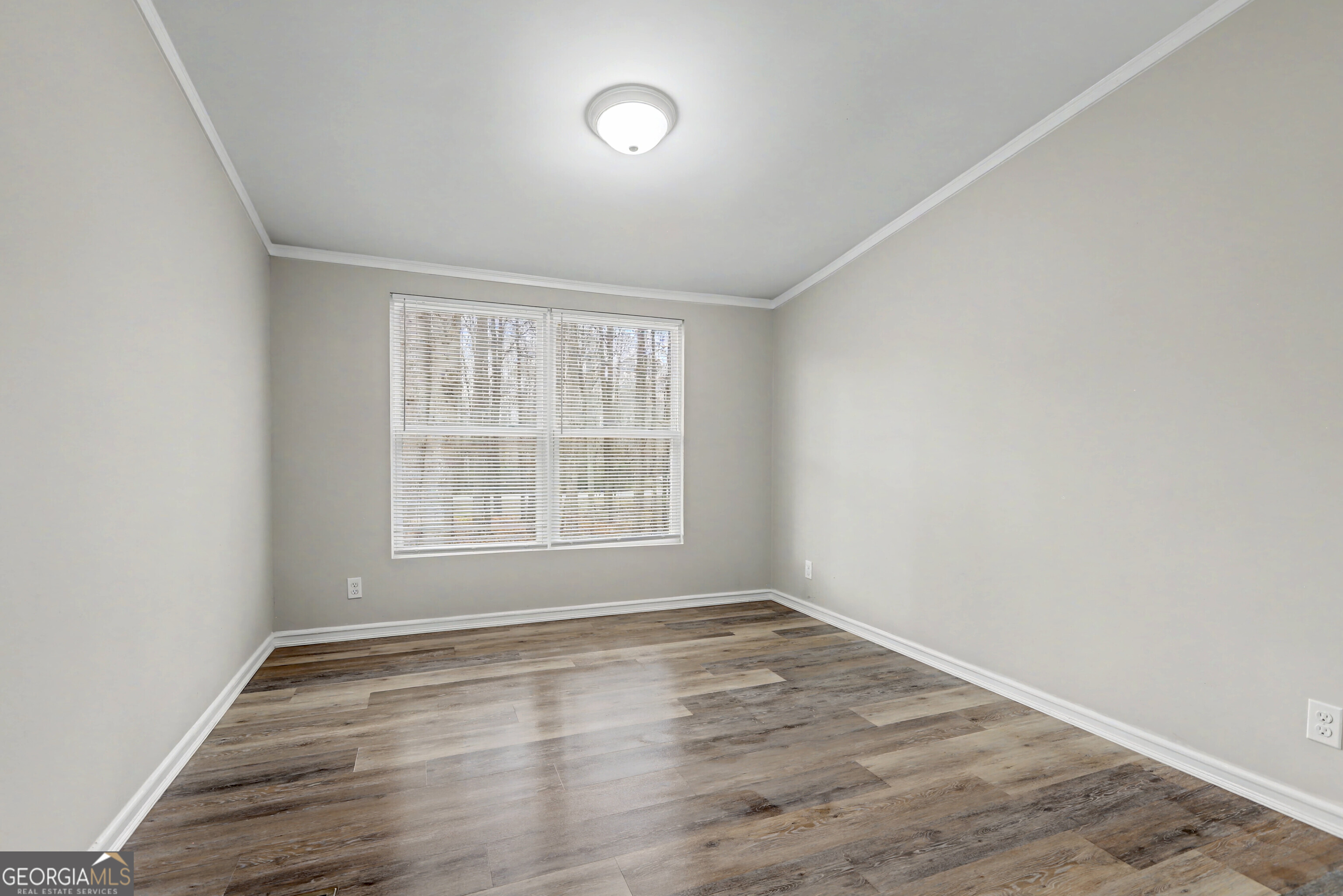 194 McKneely Road Milner, GA 30257 - Photo 22 of 30 an empty room with wooden floor and windows