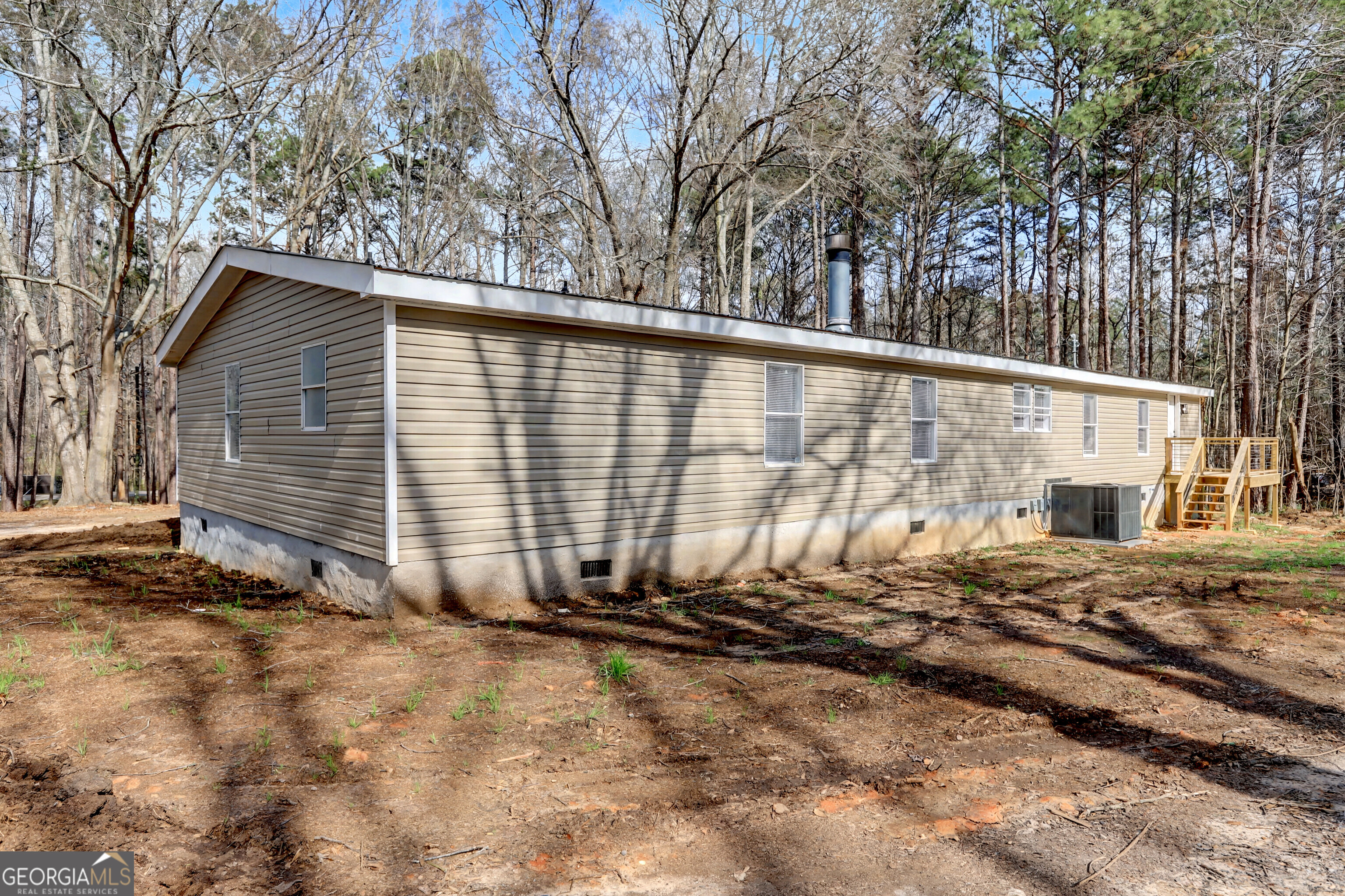 194 McKneely Road Milner, GA 30257 - Photo 3 of 30 a backyard of a house with oven and trees