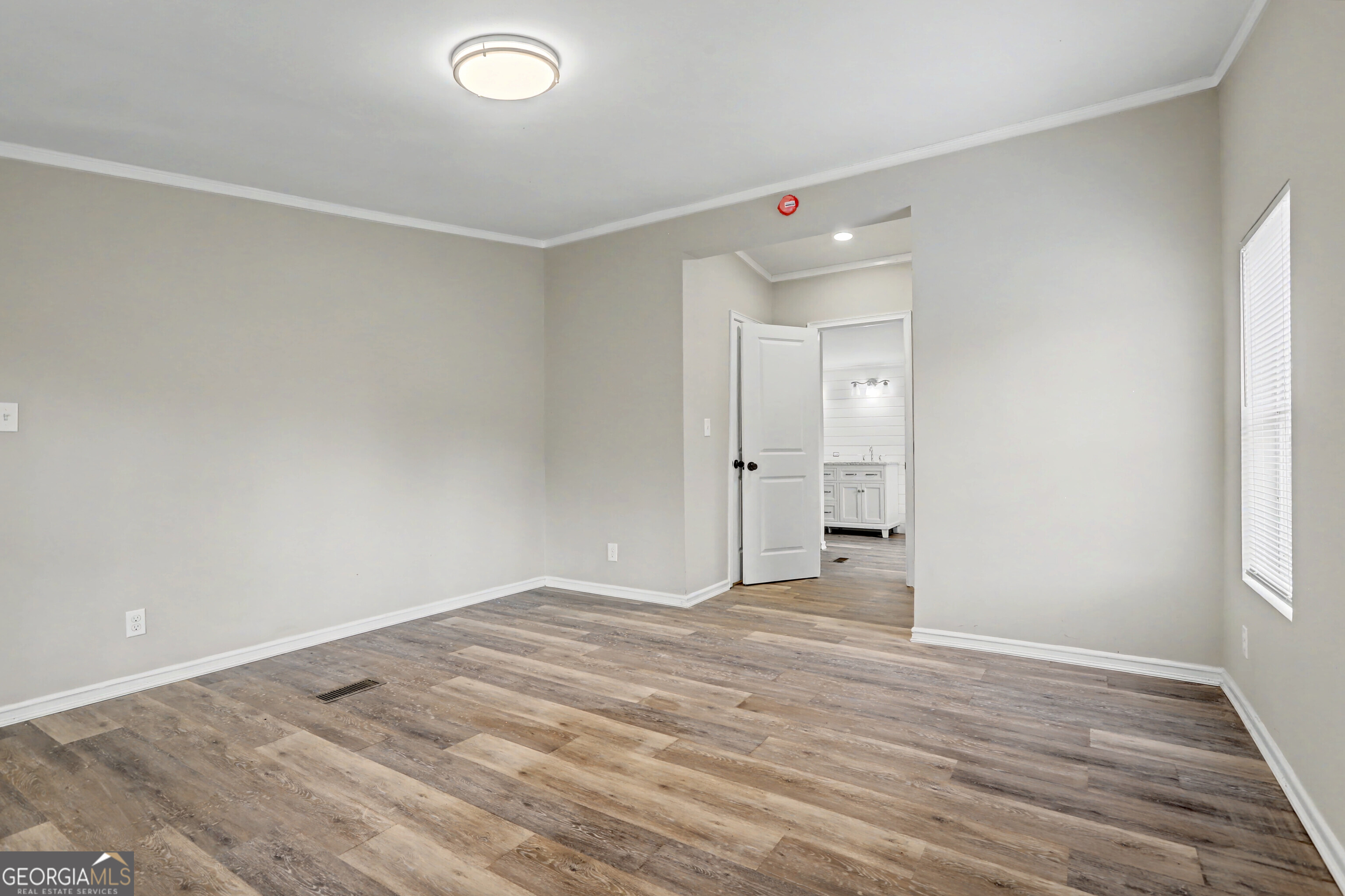 194 McKneely Road Milner, GA 30257 - Photo 10 of 30 a view of an empty room with wooden floor and a window