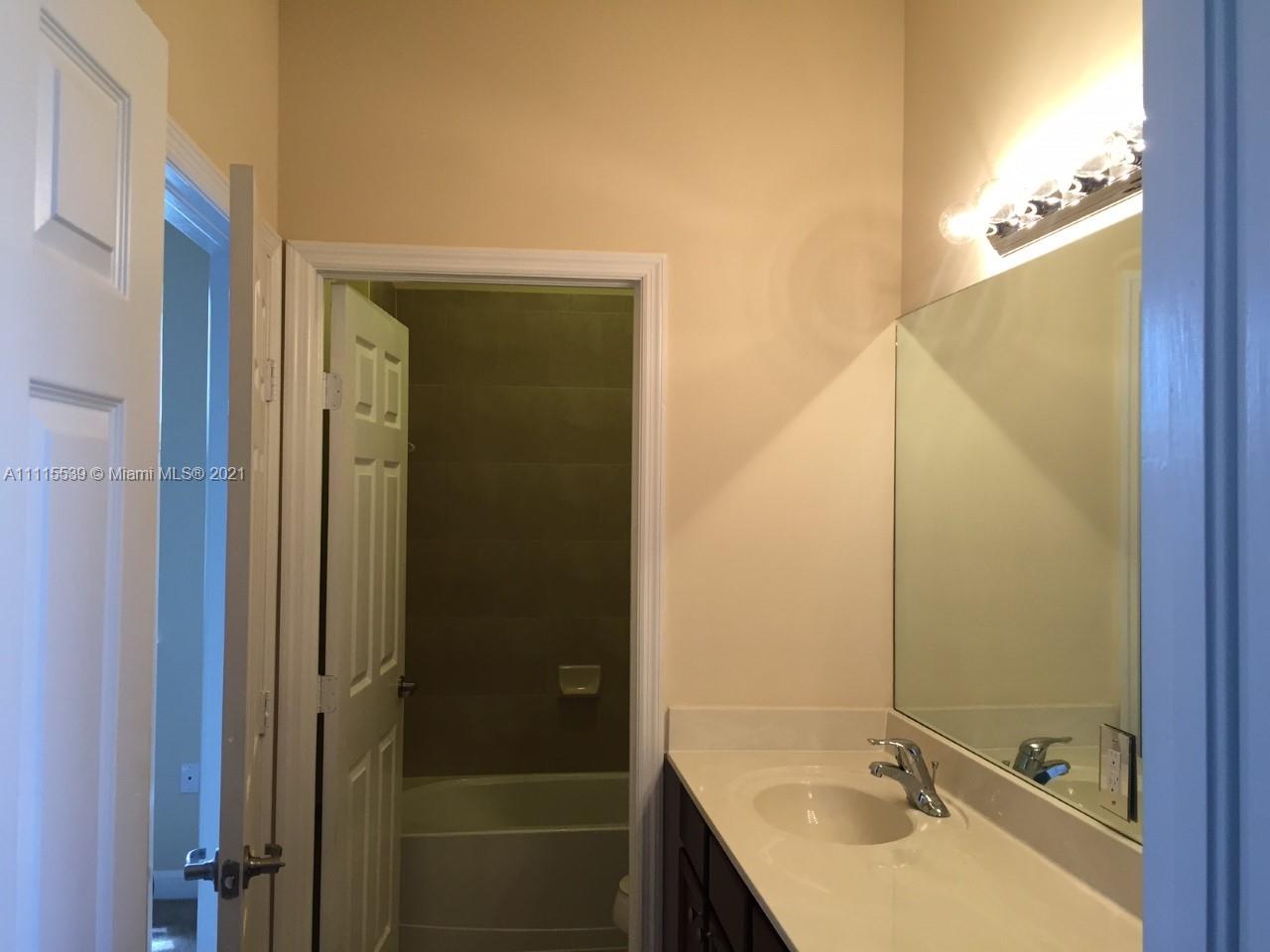 8630 West 33rd Avenue Hialeah, FL 33018 - Photo 1 of 22 a bathroom with a sink and mirror