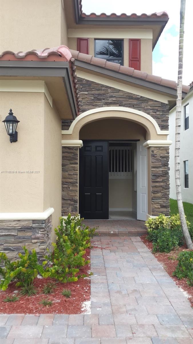 8630 West 33rd Avenue Hialeah, FL 33018 - Photo 15 of 22 a front view of a house with garden