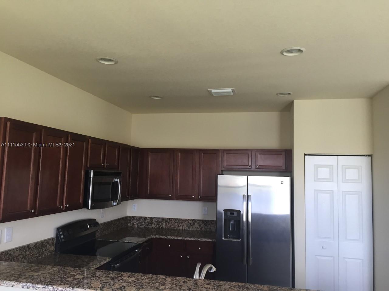 8630 West 33rd Avenue Hialeah, FL 33018 - Photo 16 of 22 a kitchen with a refrigerator and a sink