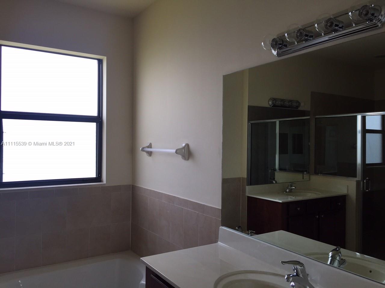 8630 West 33rd Avenue Hialeah, FL 33018 - Photo 19 of 22 a bathroom with a sink and a mirror