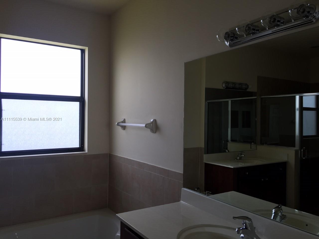8630 West 33rd Avenue Hialeah, FL 33018 - Photo 22 of 22 a bathroom with a sink and a mirror