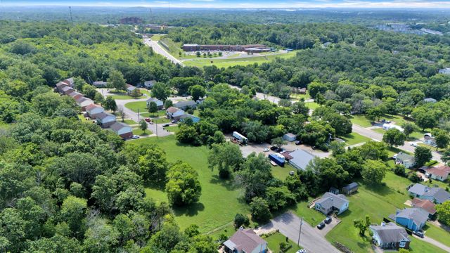 an aerial view of a house with yard