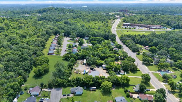 an aerial view of a houses with a yard