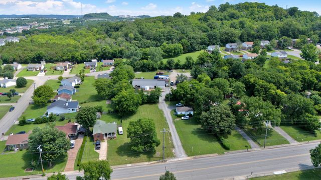 an aerial view of a house with yard