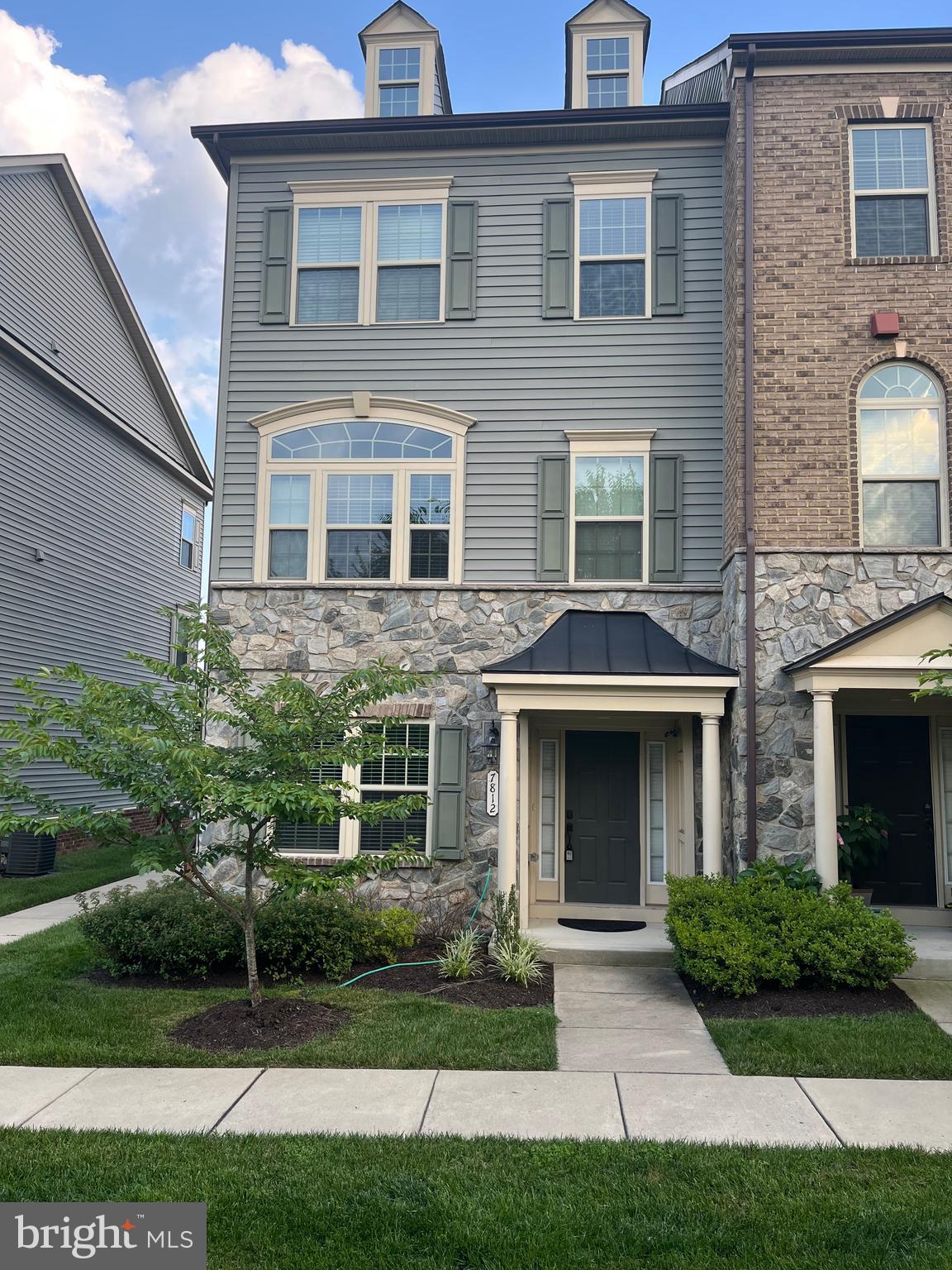 7812 Patterson Way Hanover, MD 21076 - Photo 1 of 15 a front view of a house with yard and green space