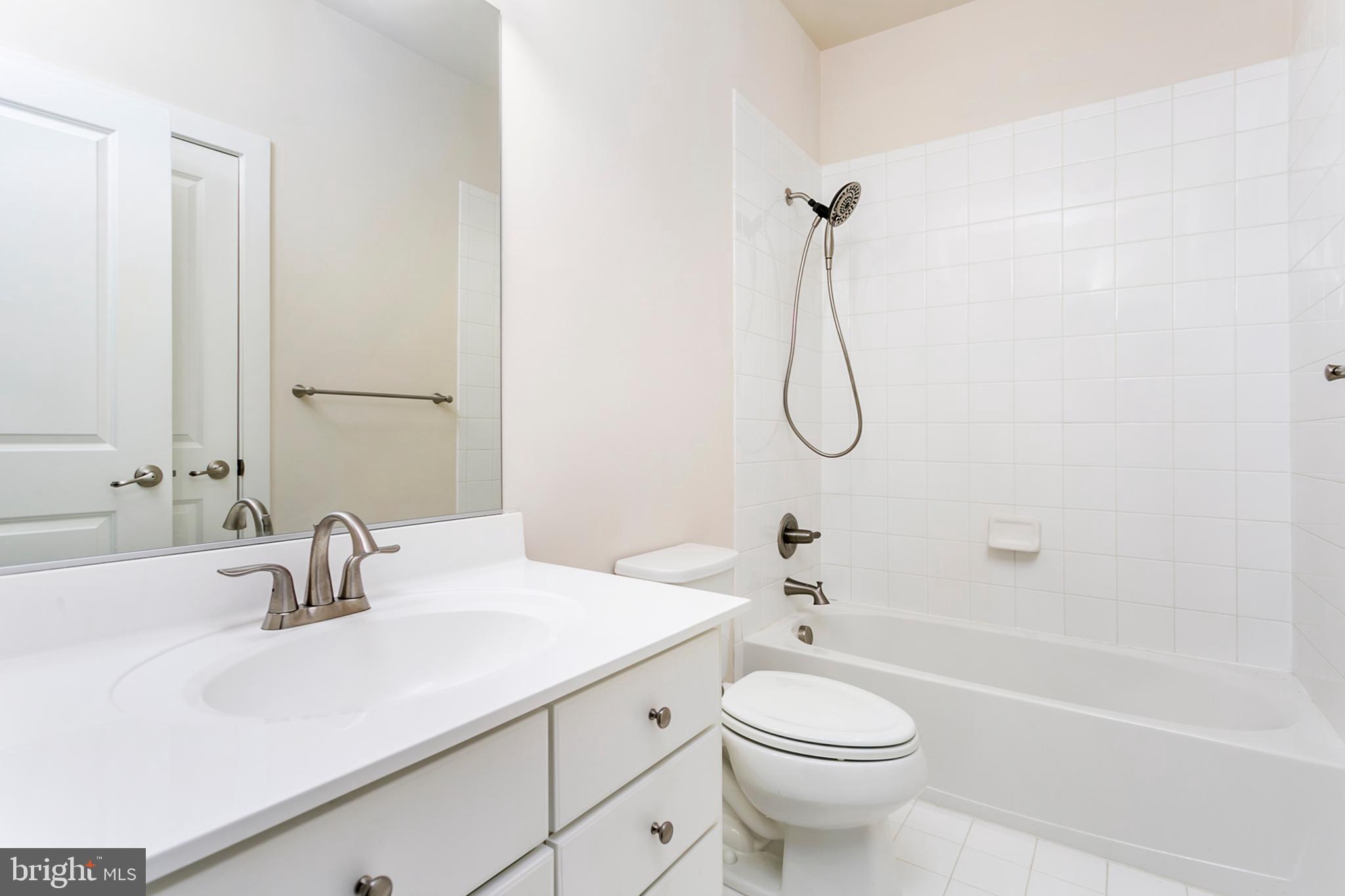 7812 Patterson Way Hanover, MD 21076 - Photo 13 of 15 a bathroom with a sink a toilet and a mirror