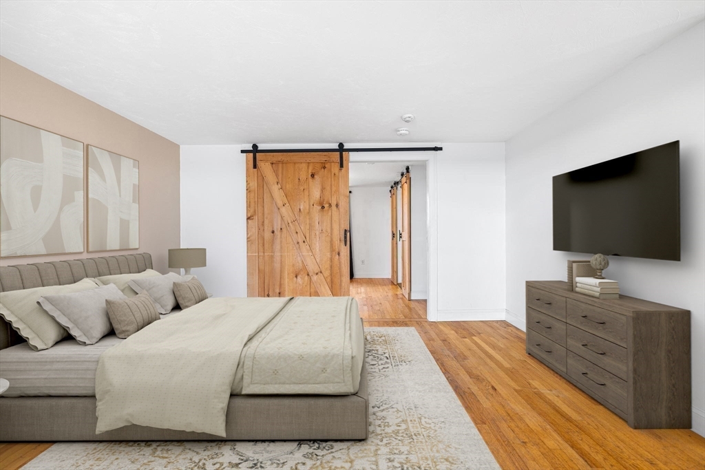 544 Shore Road, Unit 3 Truro, MA 02666 - Photo 20 of 30 a bedroom with a bed and a flat screen tv