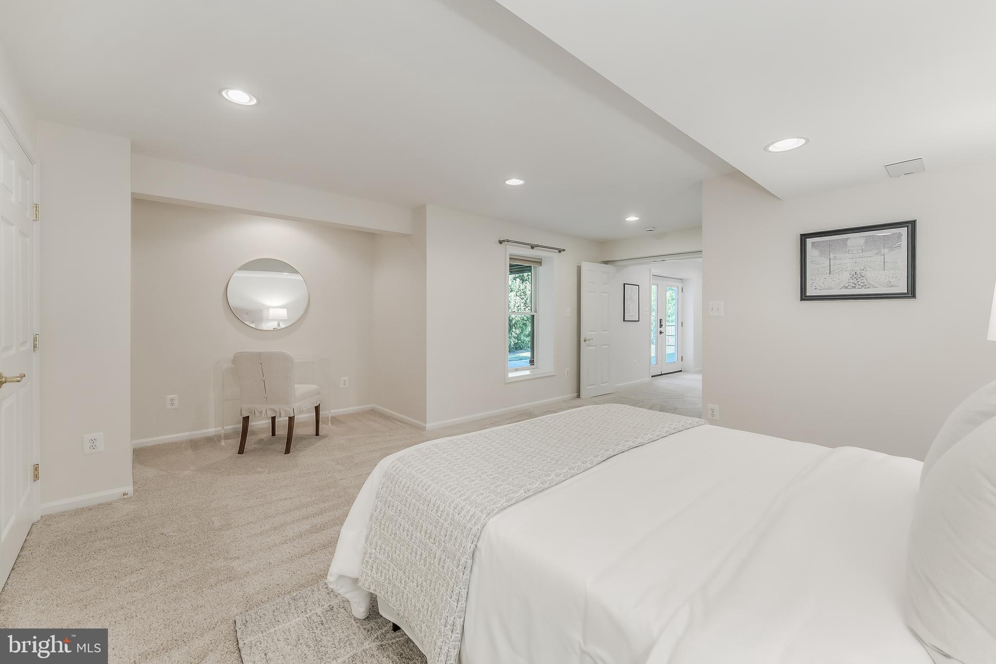 12537 Ridgegate Drive Herndon, VA 20170 - Photo 64 of 80 a spacious bedroom with a bed and a lamp