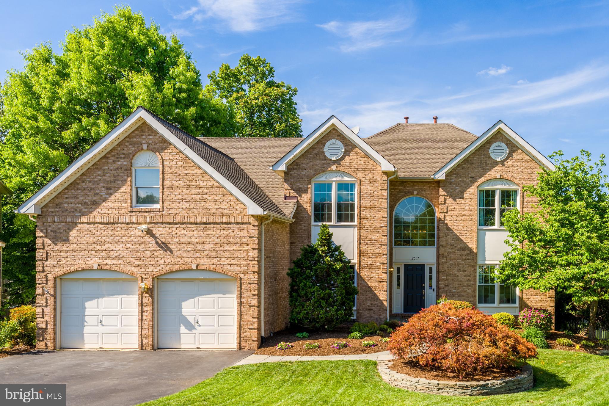 12537 Ridgegate Drive Herndon, VA 20170 - Photo 70 of 80 a front view of a house with a yard and garage
