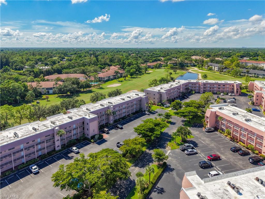 200 Turtle Lake Court, Unit 109 Naples, FL 34105 - Photo 1 of 37 Bird's eye view of a golf club and a nearby body of water