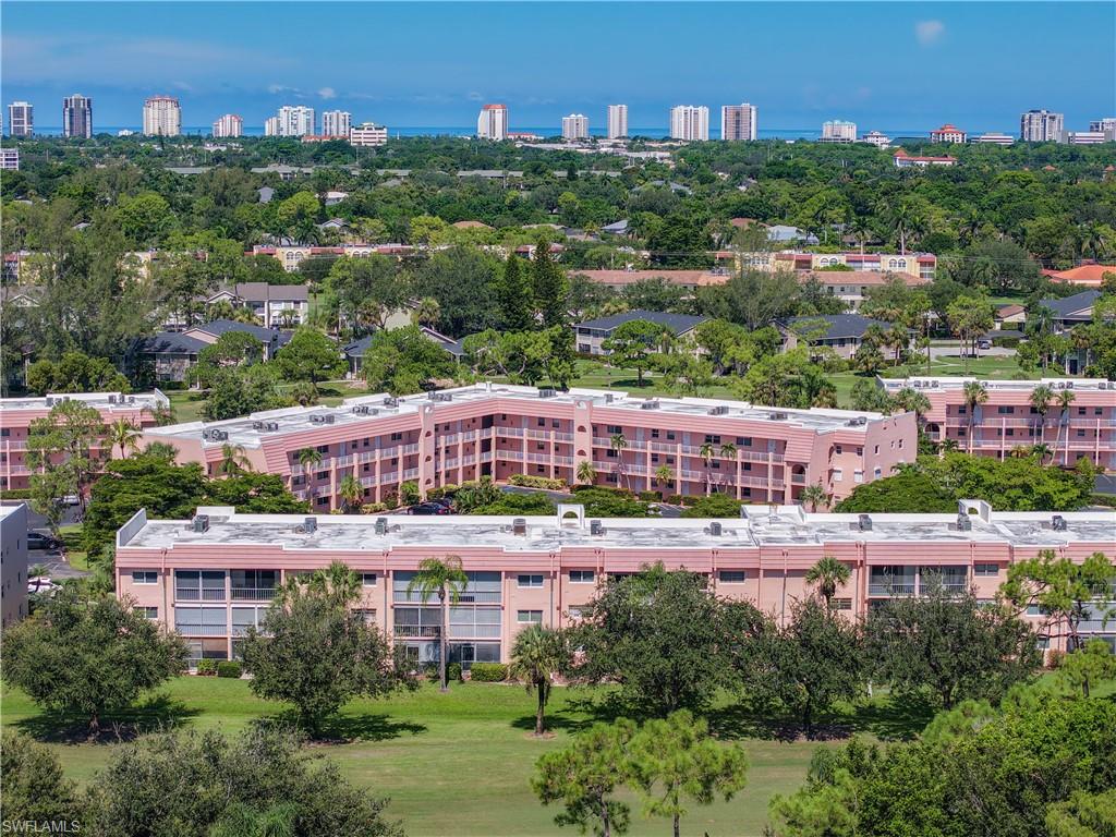 200 Turtle Lake Court, Unit 109 Naples, FL 34105 - Photo 37 of 37 View of urban area featuring a tree filled landscape