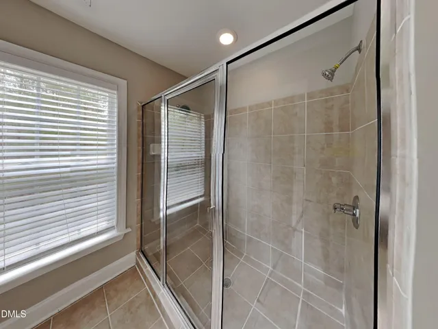 a bathroom with a shower and a window