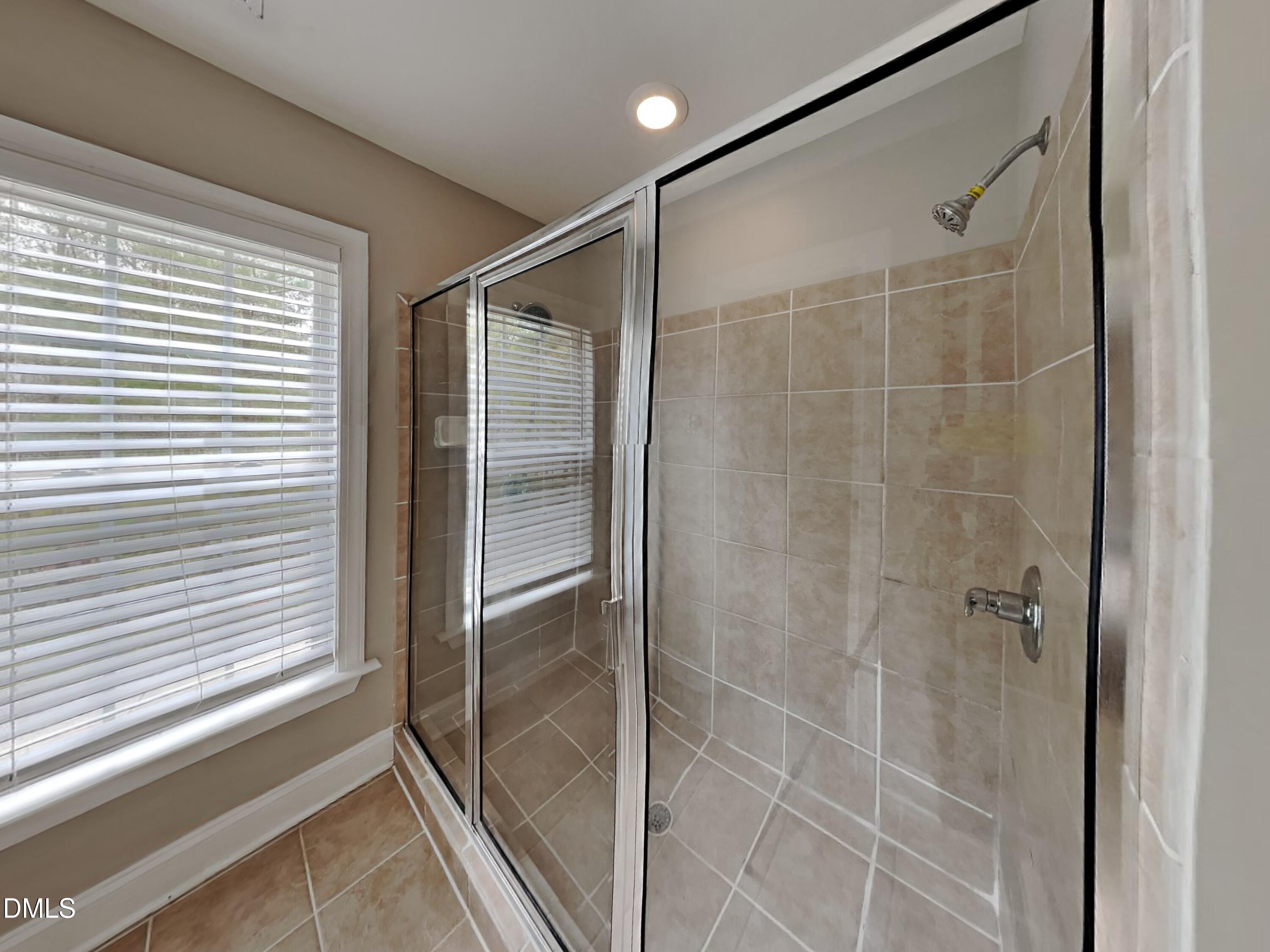 9531 Waterwood Court Raleigh, NC 27614 - Photo 11 of 19 a bathroom with a shower and a window