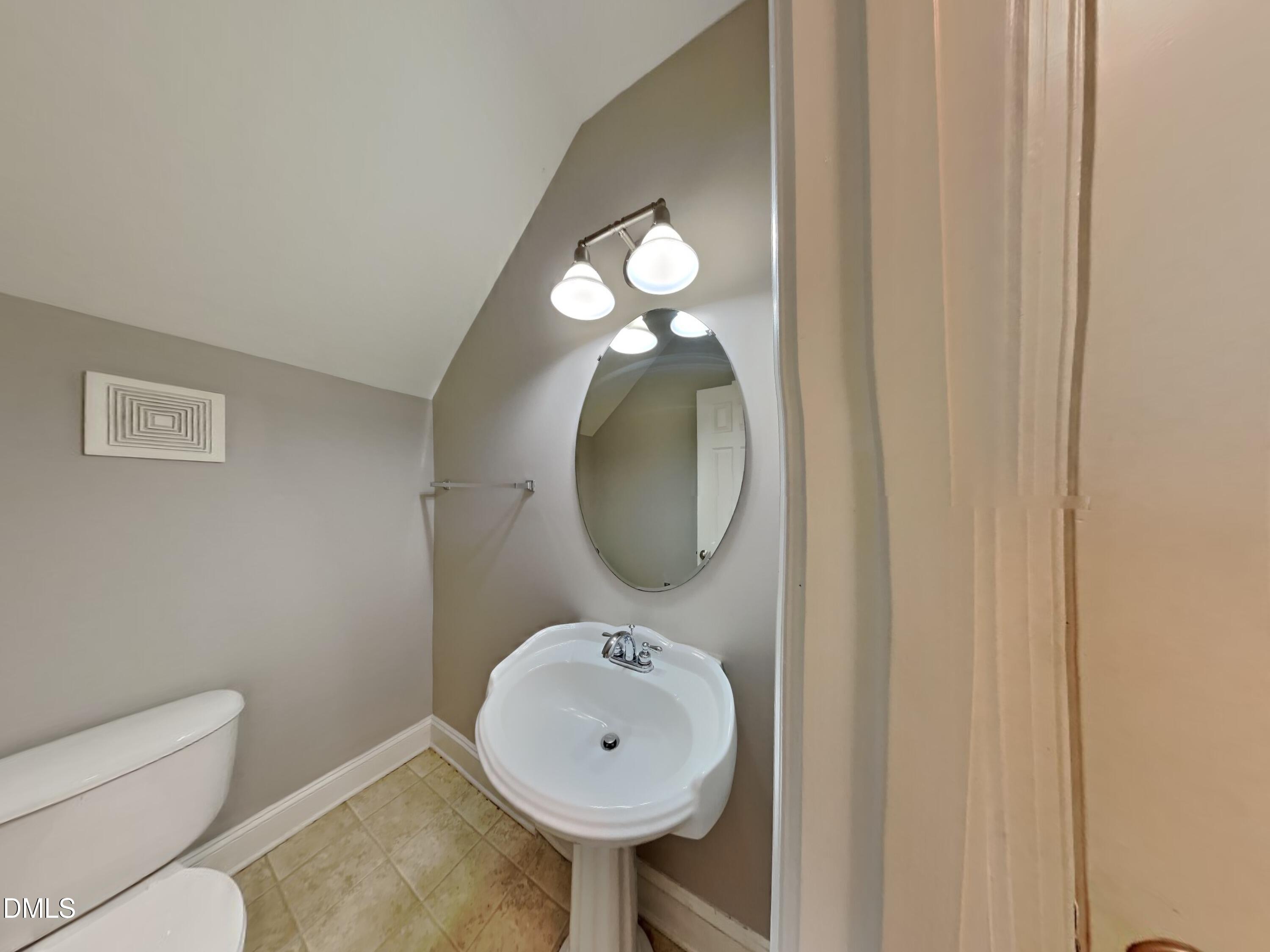 9531 Waterwood Court Raleigh, NC 27614 - Photo 17 of 19 a bathroom with a sink and a mirror