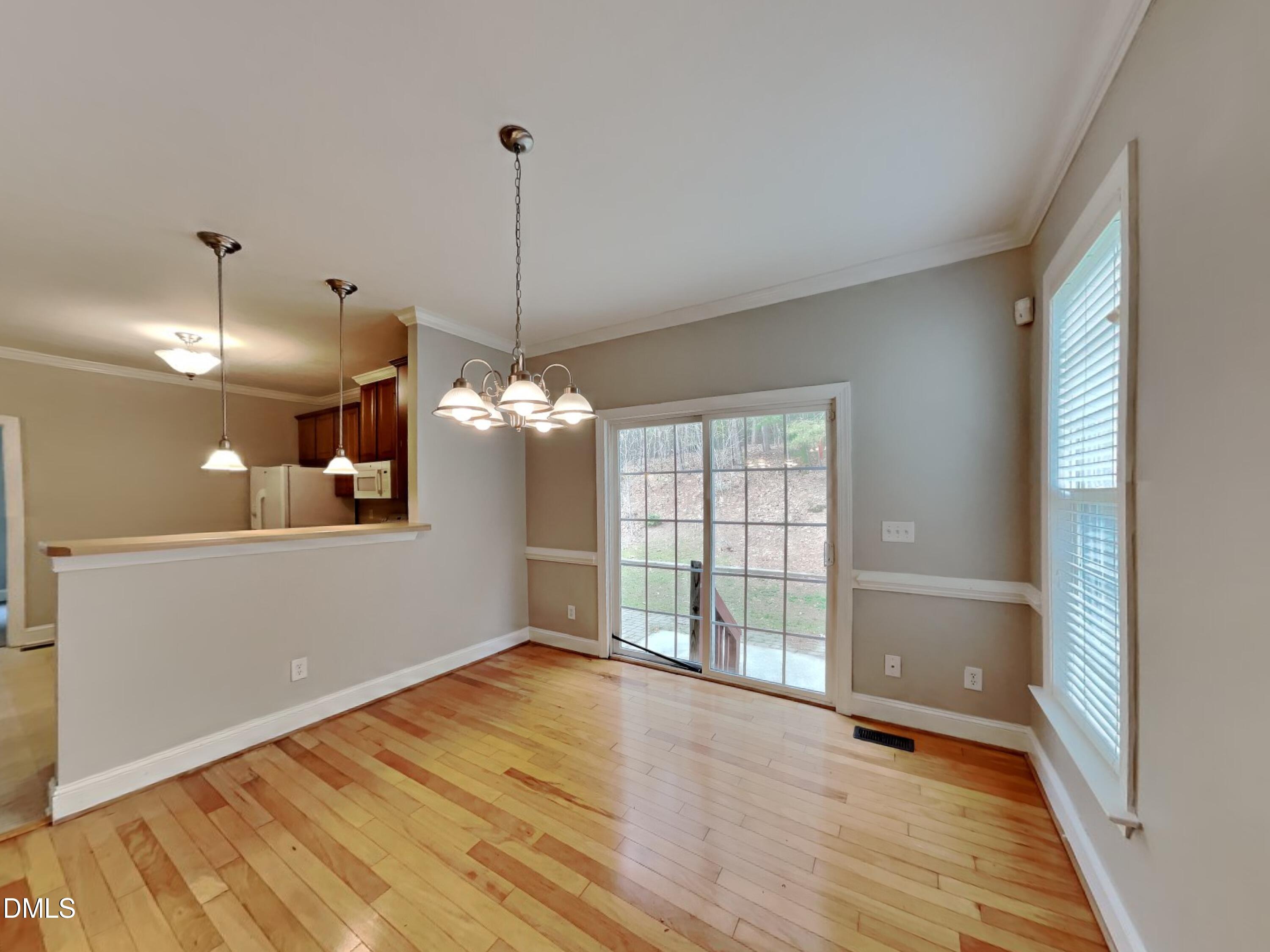 9531 Waterwood Court Raleigh, NC 27614 - Photo 4 of 19 a view of an empty room with wooden floor and a window