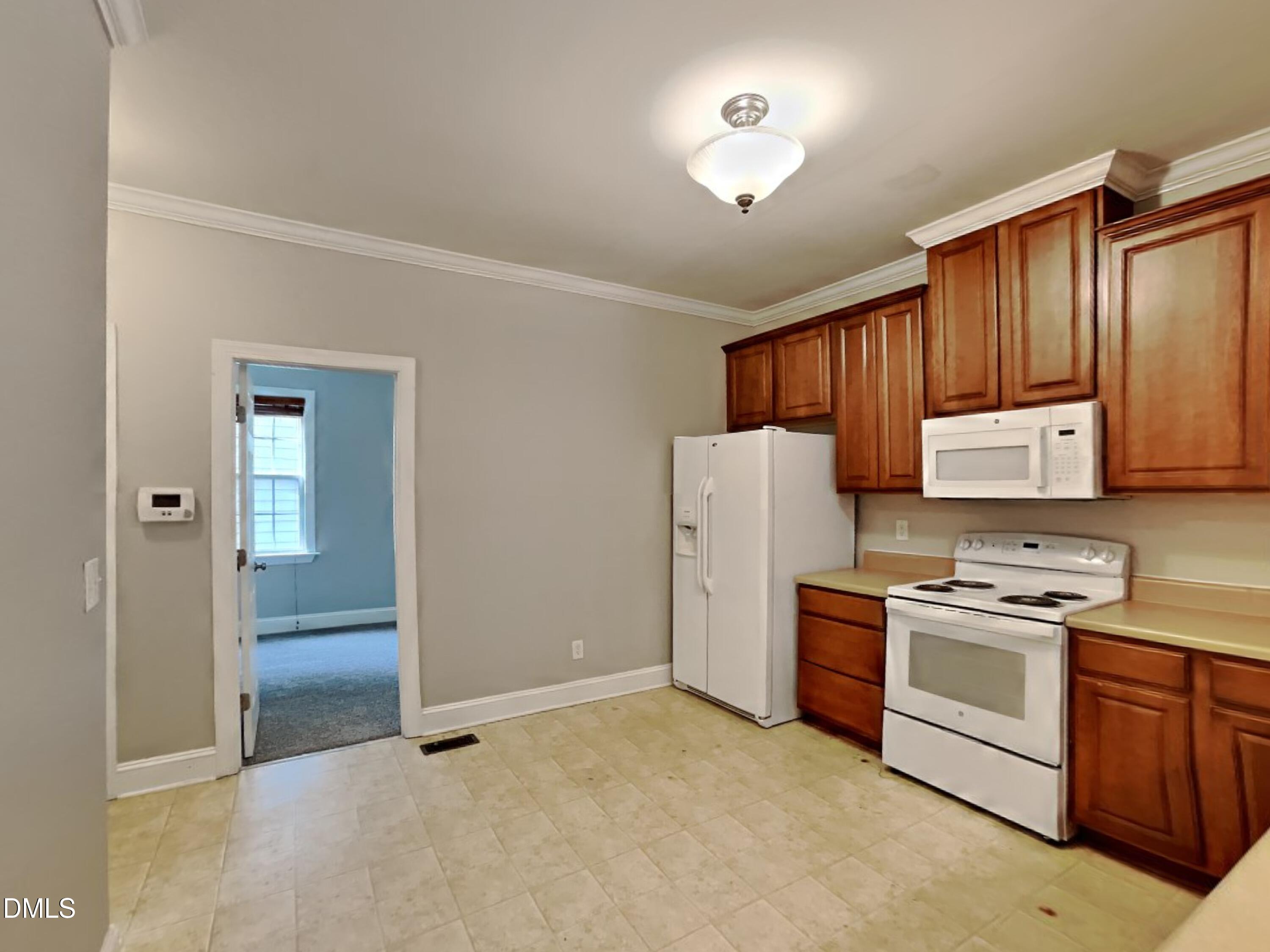 9531 Waterwood Court Raleigh, NC 27614 - Photo 5 of 19 a kitchen with a refrigerator a stove a sink and cabinets
