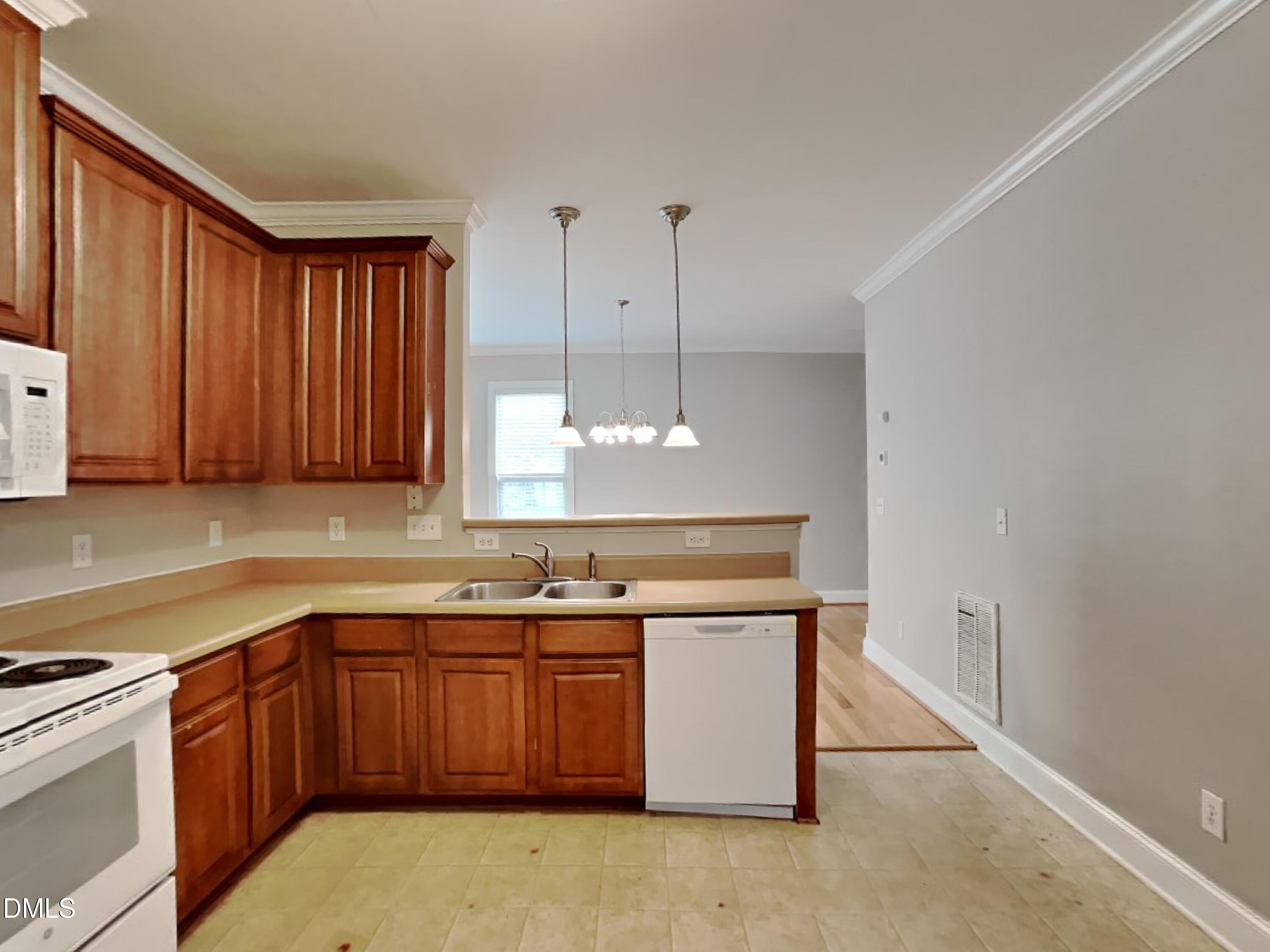 9531 Waterwood Court Raleigh, NC 27614 - Photo 6 of 19 a kitchen with a sink stove and cabinets