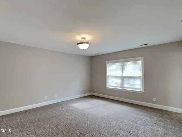 an empty room with a empty space and windows