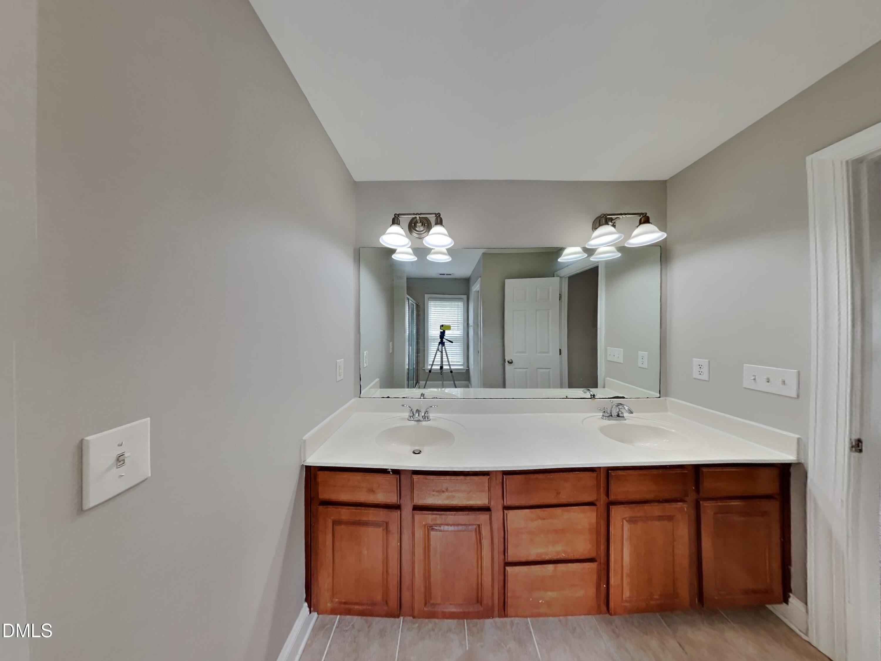 9531 Waterwood Court Raleigh, NC 27614 - Photo 10 of 19 a bathroom with a double vanity sink and a mirror
