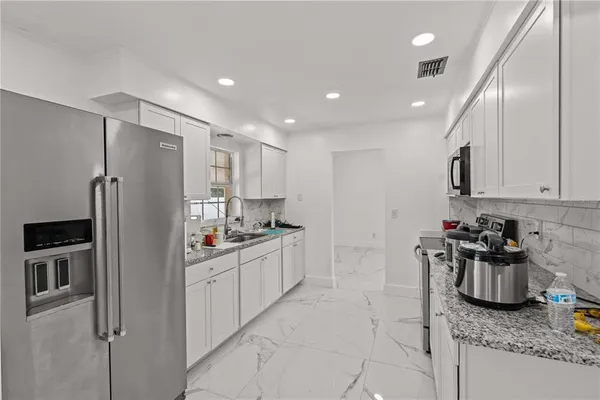 a living room with furniture fireplace and chandelier