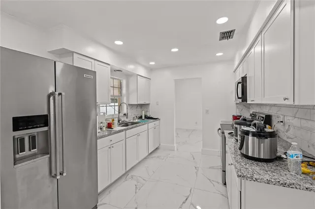 a living room with furniture fireplace and chandelier
