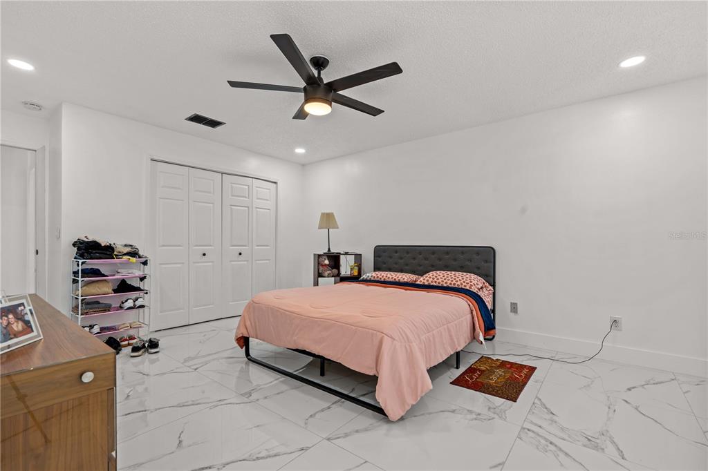 3104 Apricot Street Seffner, FL 33584 - Photo 20 of 31 a bedroom with a bed and a ceiling fan