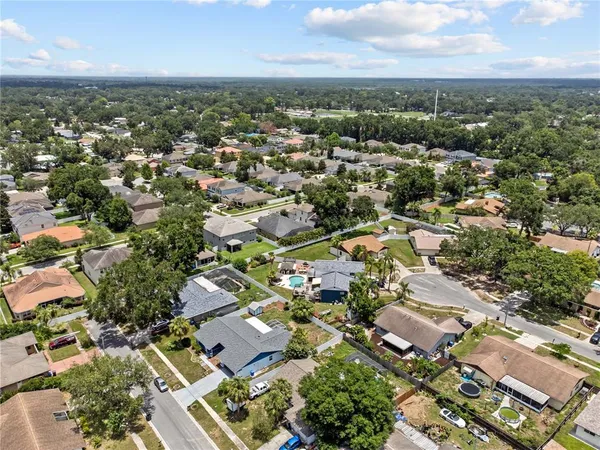 an aerial view of residential building with green space