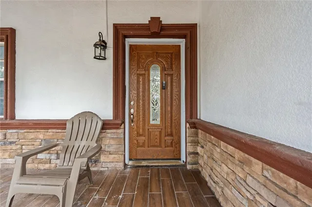 a view of a hallway with wooden floor and furniture