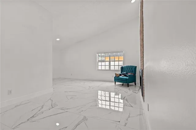 a view of a entryway with furniture and a fireplace