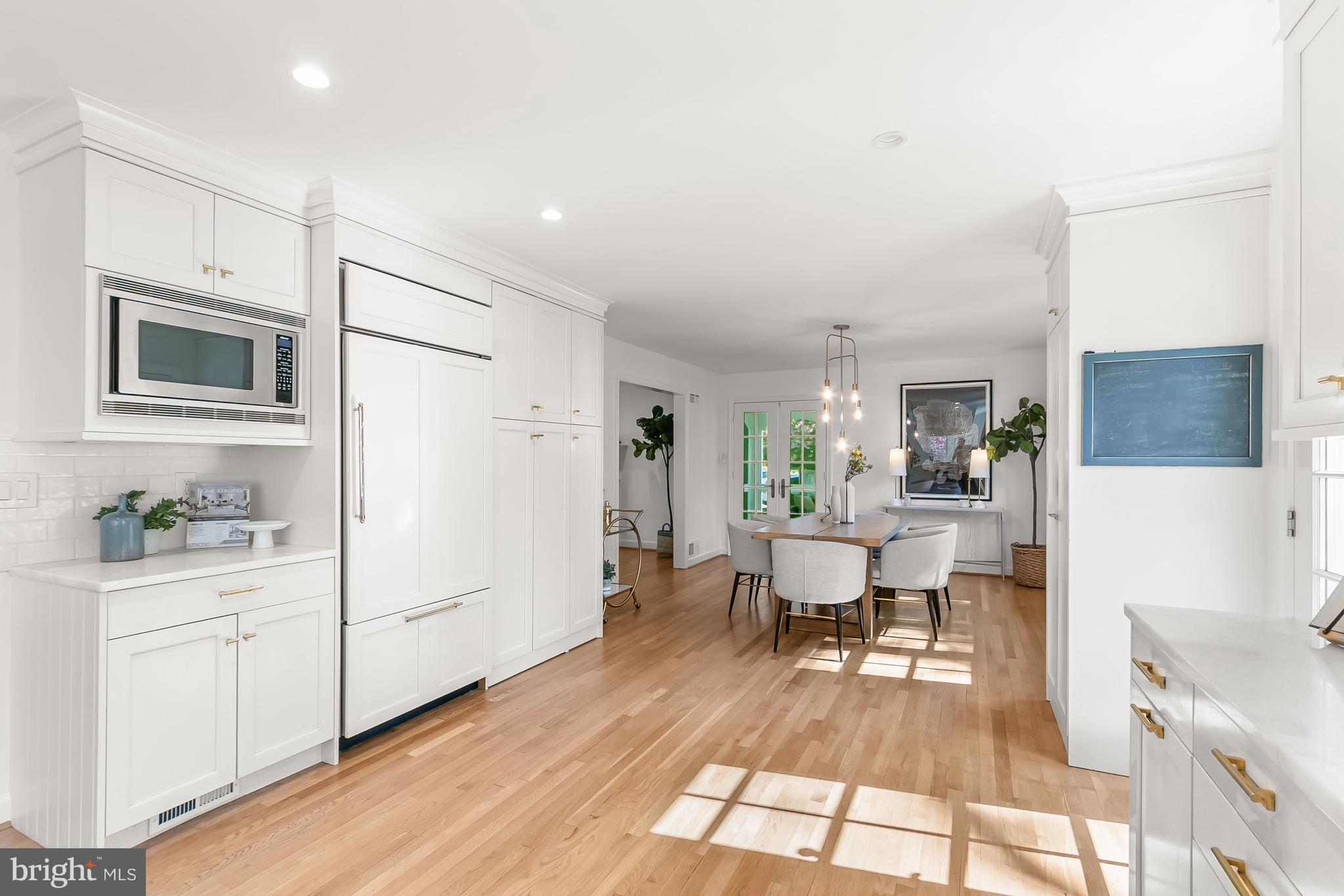 5120 Upton Street Northwest Washington, DC 20016 - Photo 11 of 53 a living room with furniture a flat screen tv and kitchen view