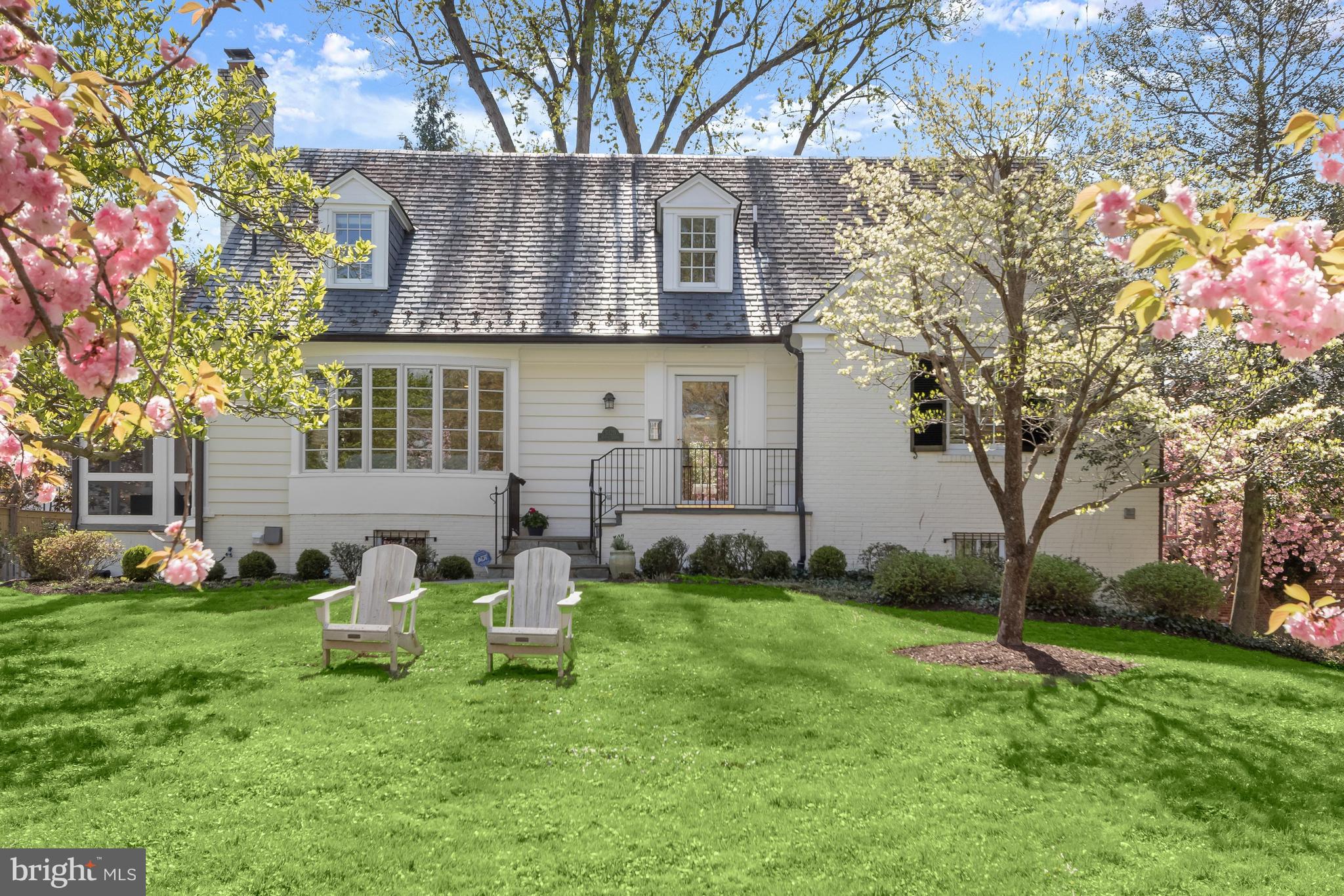 5120 Upton Street Northwest Washington, DC 20016 - Photo 2 of 53 a front view of a house with garden and trees