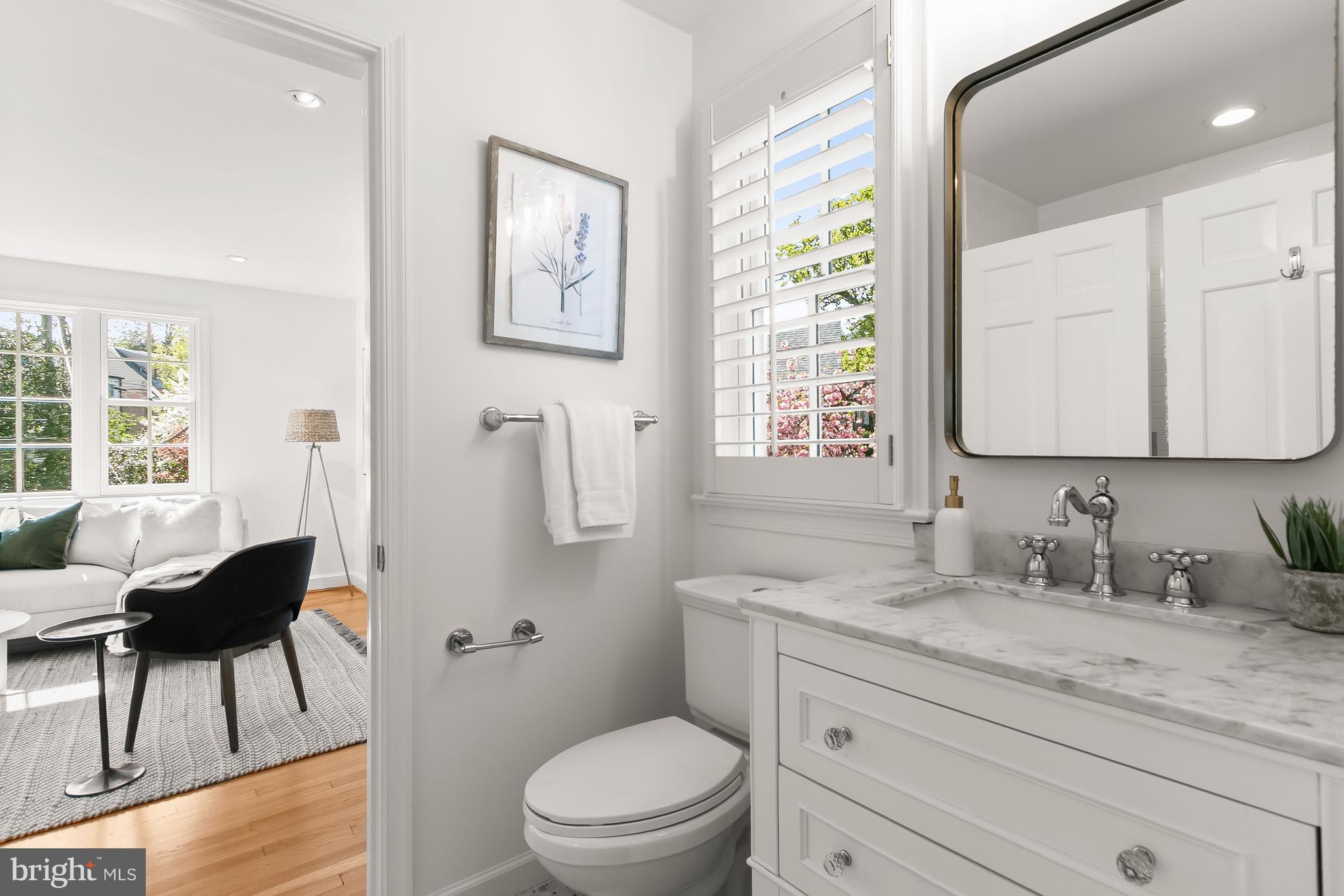 5120 Upton Street Northwest Washington, DC 20016 - Photo 24 of 53 a bathroom with a granite countertop sink a toilet and a mirror