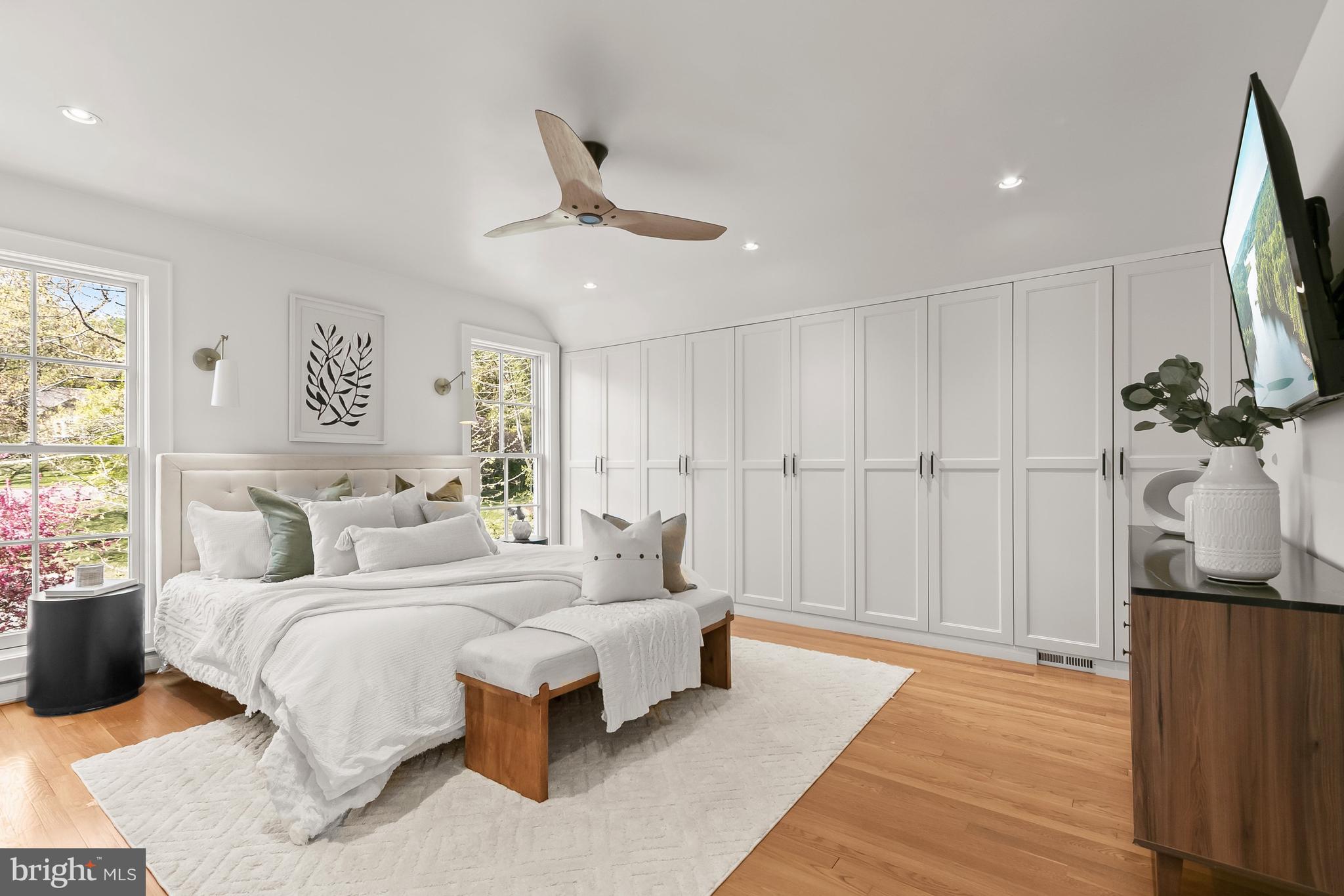 5120 Upton Street Northwest Washington, DC 20016 - Photo 26 of 53 a bedroom with a large bed and a chandelier